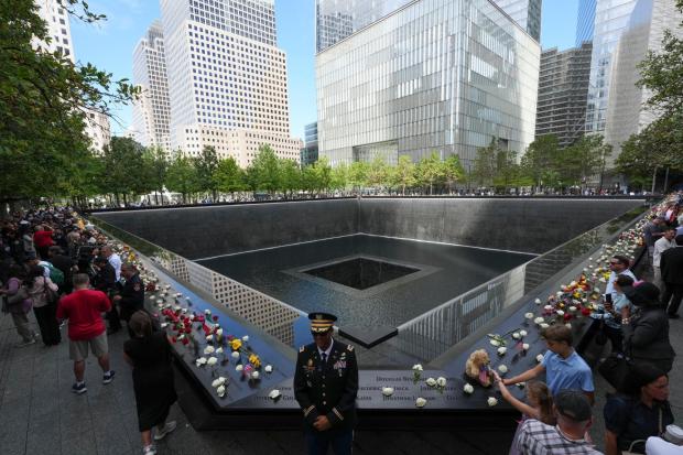 A U.S. Army warrant officer stands by a reflecting pool during a memorial on the 25th anniversary of the September 11, 2001, terrorist attacks, Friday, Sept. 11, 2026, in New York. (AP Photo/Adam Gray, Pool)