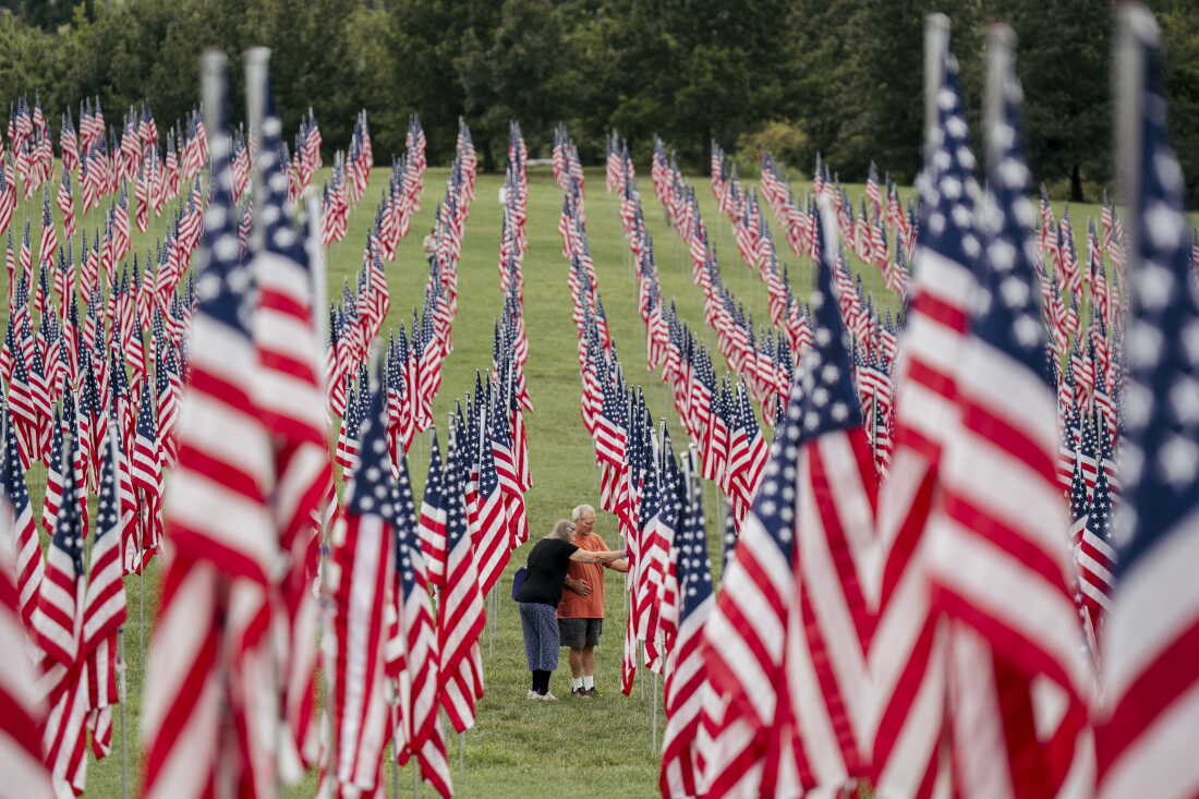 Darlene Johnson and David Johnson, both of Florissant, look over one of the flags at the “Flags of Valor” installation on Thursday, Sept. 10, 2026, at Art Hill in Forest Park, St. Louis, Mo.