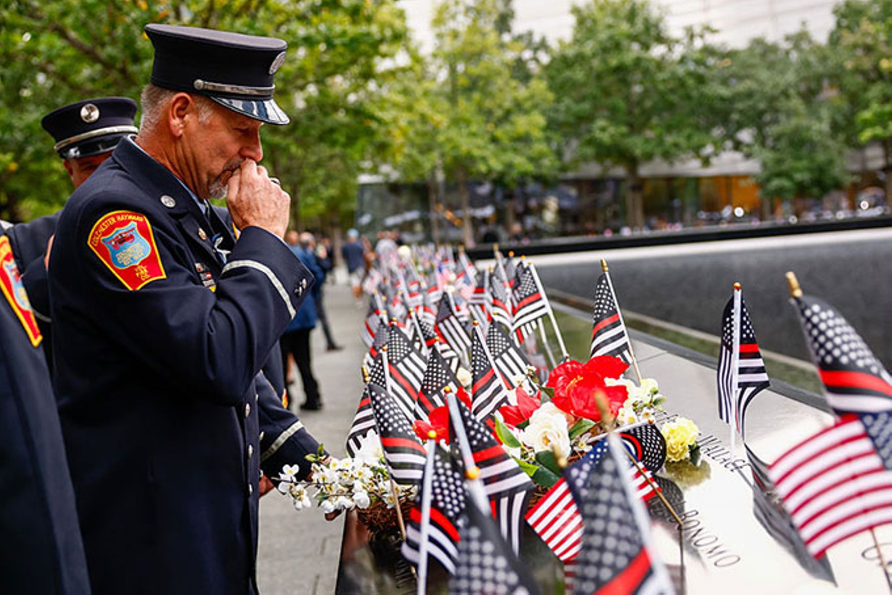 Fire Department of New York firefighters pay their respects at the 25th Anniversary Of 9/11 Attacks Memorialized In New York City.