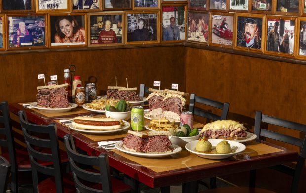 The full spread. Matzoh ball soup, corned beef sandwich, the "Lunch-Before-Lunch" footlong hot dog, Broadway Danny Rose pastrami sandwich, the Carnegie Deli Colossus corned beef Reuben, french fries, and the "Full Lee Loaded Reuben Fries" will be available at the newly reopened Carnegie Deli in Midtown Manhattan. (Photo by Evan Sung)