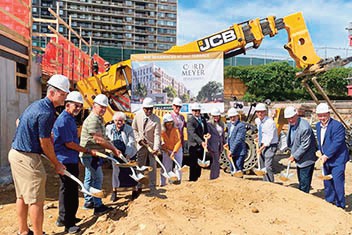 Cord Meyer Development recently broke ground on its new residential community at the Bay Ter­race Shopping Center, marking a major investment in new housing. Queens Borough President Donovan Richards Jr. and New York City Council Member Vickie Paladino (fifth and sixth from left) joined Cord Meyer executives, community leaders, and other elected officials for the cere­mony.