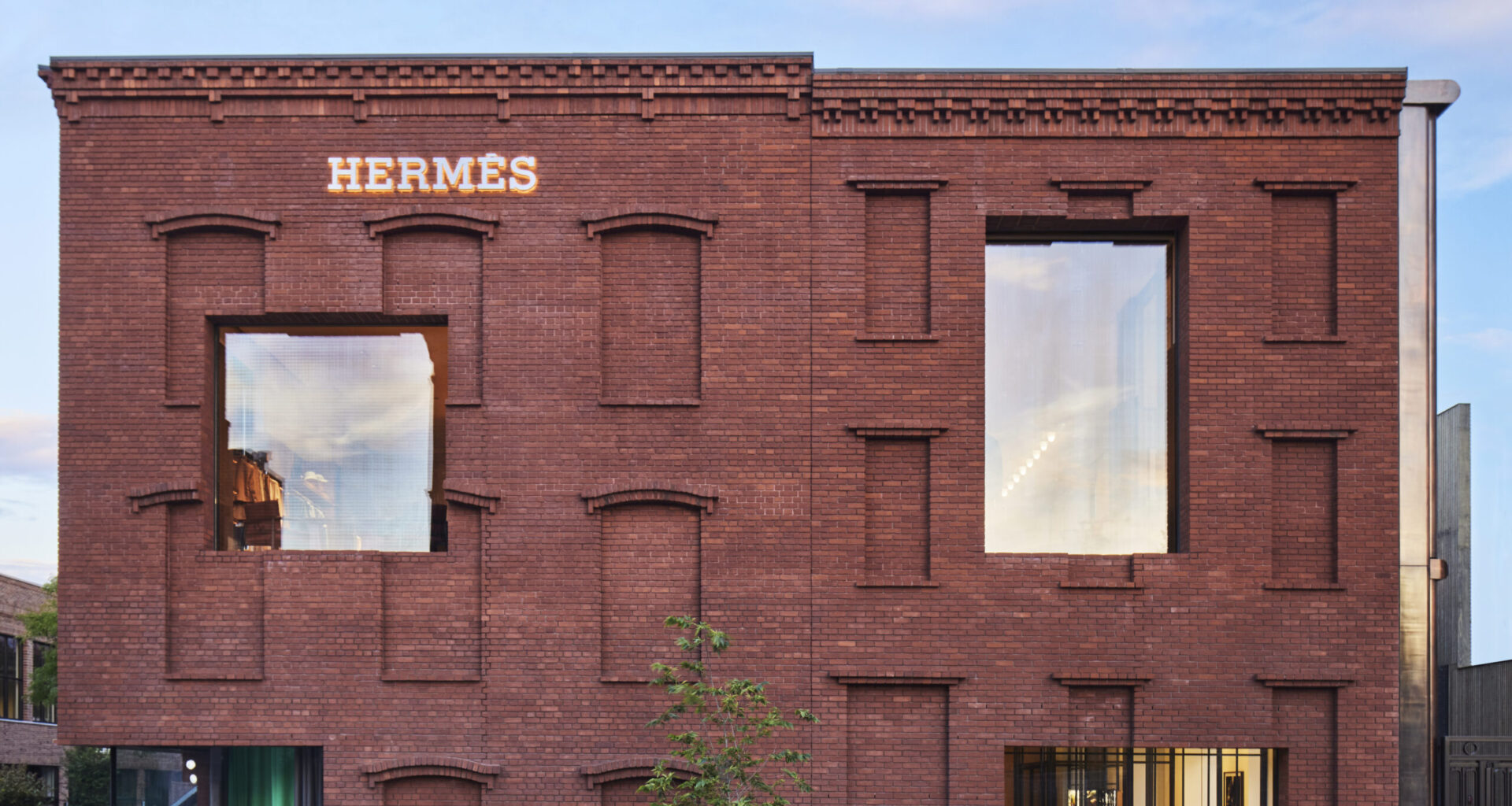The exterior of the new Hermès Williamsburg store, including its brick facade and wide windows