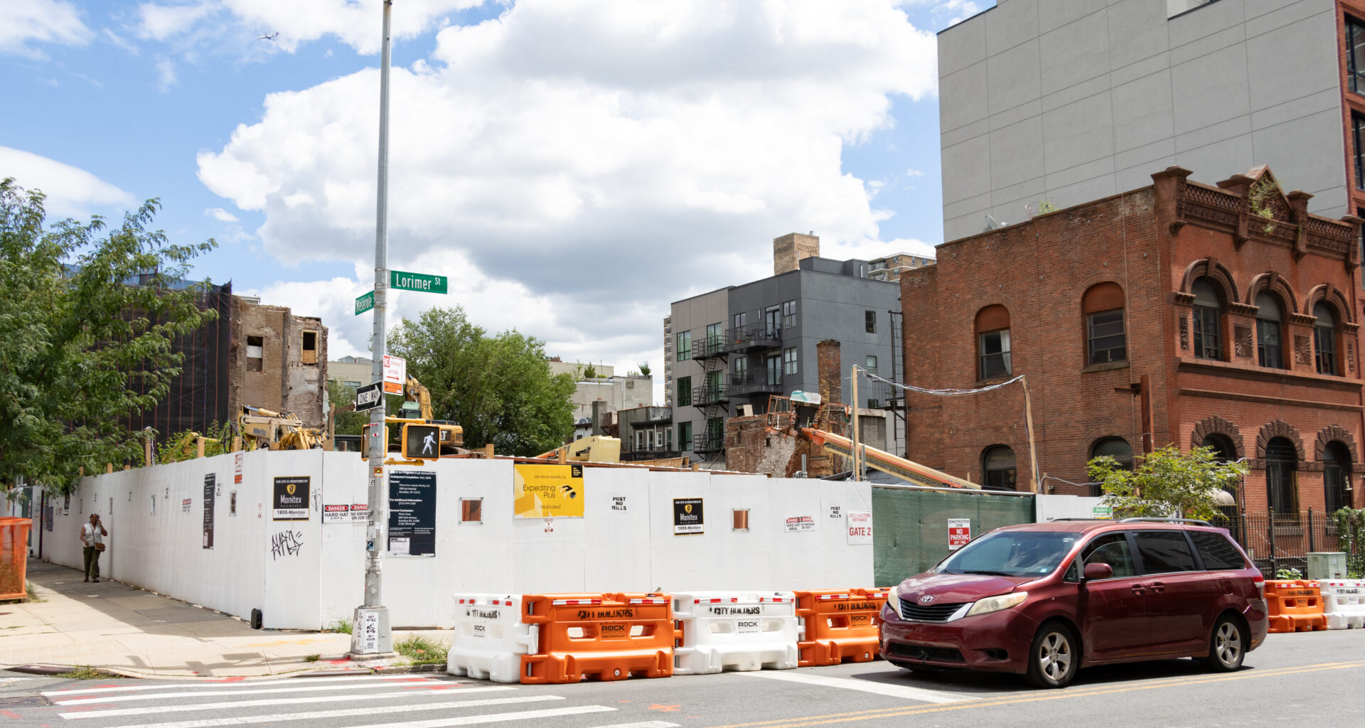 demolition site surrounded by a white construction fence