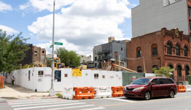 demolition site surrounded by a white construction fence