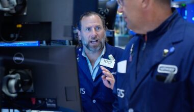 Wall Street holds near record after Brent oil briefly falls below $98