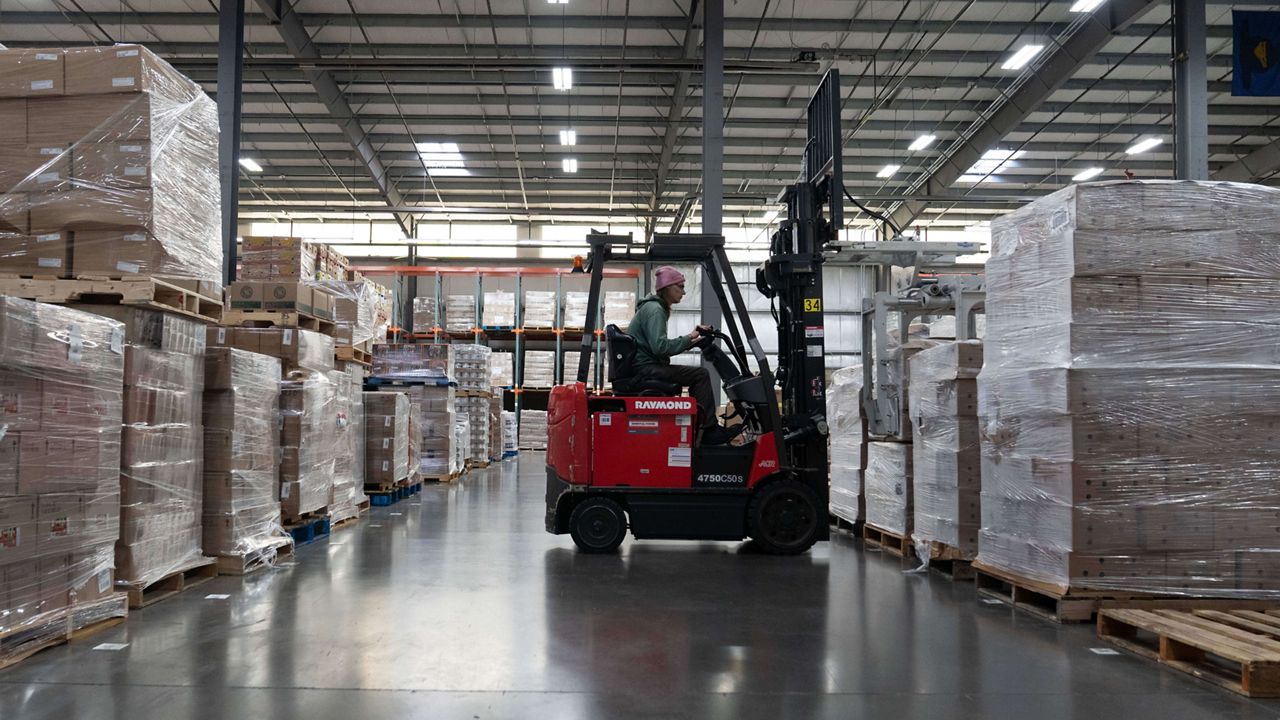 A warehouse worker prepares to move a pallet at the Oregon Food Bank in Portland, Ore., Wednesday, Oct. 29, 2025. (AP Photo/Jenny Kane)