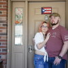 Kevin and Jenny Conlon in front of their home on Monday, March 10, 2025, in Queensbury, N.Y. Kevin Conlon is an Iraq war combat veteran who has struggled with PTSD and traumatic brain injury related to IED explosions. The Conlons have been left in the lurch while they try to get up-to-date on mortgage payments through a Veterans’ Administration home loan program. Cindy Schultz for NPR