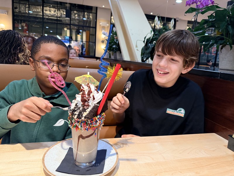 Kids with a decorated milkshake at Carnegie Diner in DeKalb Market Hall