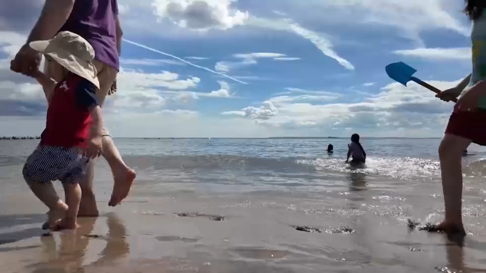 Coney Island beachgoers soaking it in before school starts again