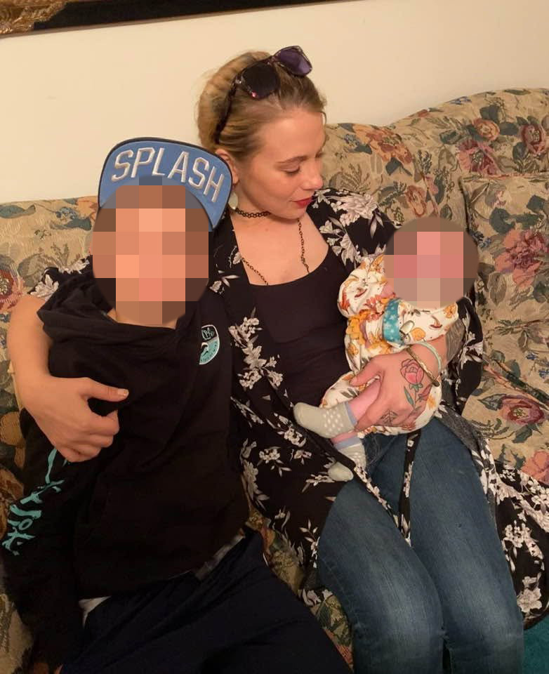 Taylor Gosnell with her two children, whose faces are blurred.