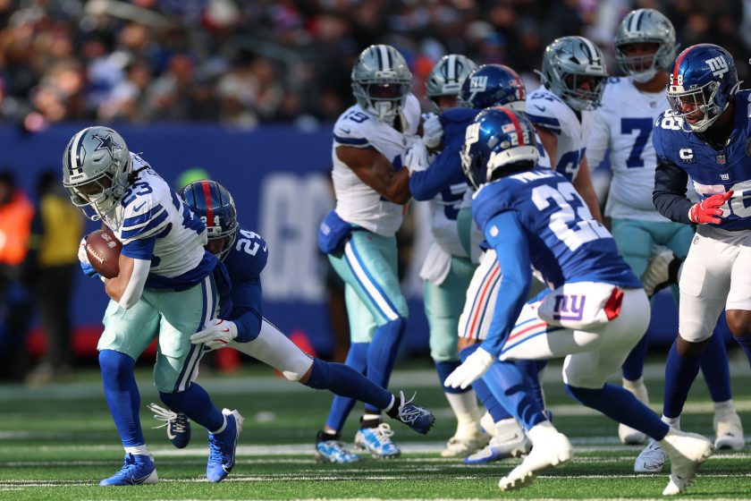 Jan 4, 2026; East Rutherford, New Jersey, USA; Dallas Cowboys running back Jaydon Blue (23) is tackled by New York Giants safety Dane Belton (24) during the first half at MetLife Stadium.