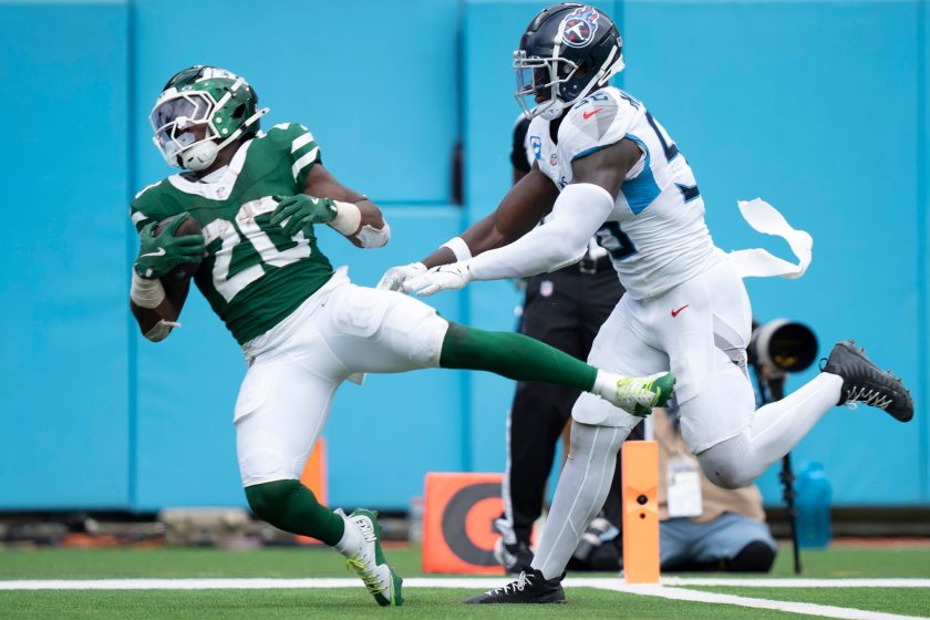 New York Jets running back Breece Hall (20) comes down with a touchdown pass while defended by Tennessee Titans linebacker Kenneth Murray Jr. (56) during their game at Nissan Stadium in Nashville, Tenn., Sunday, Sept. 15, 2024.