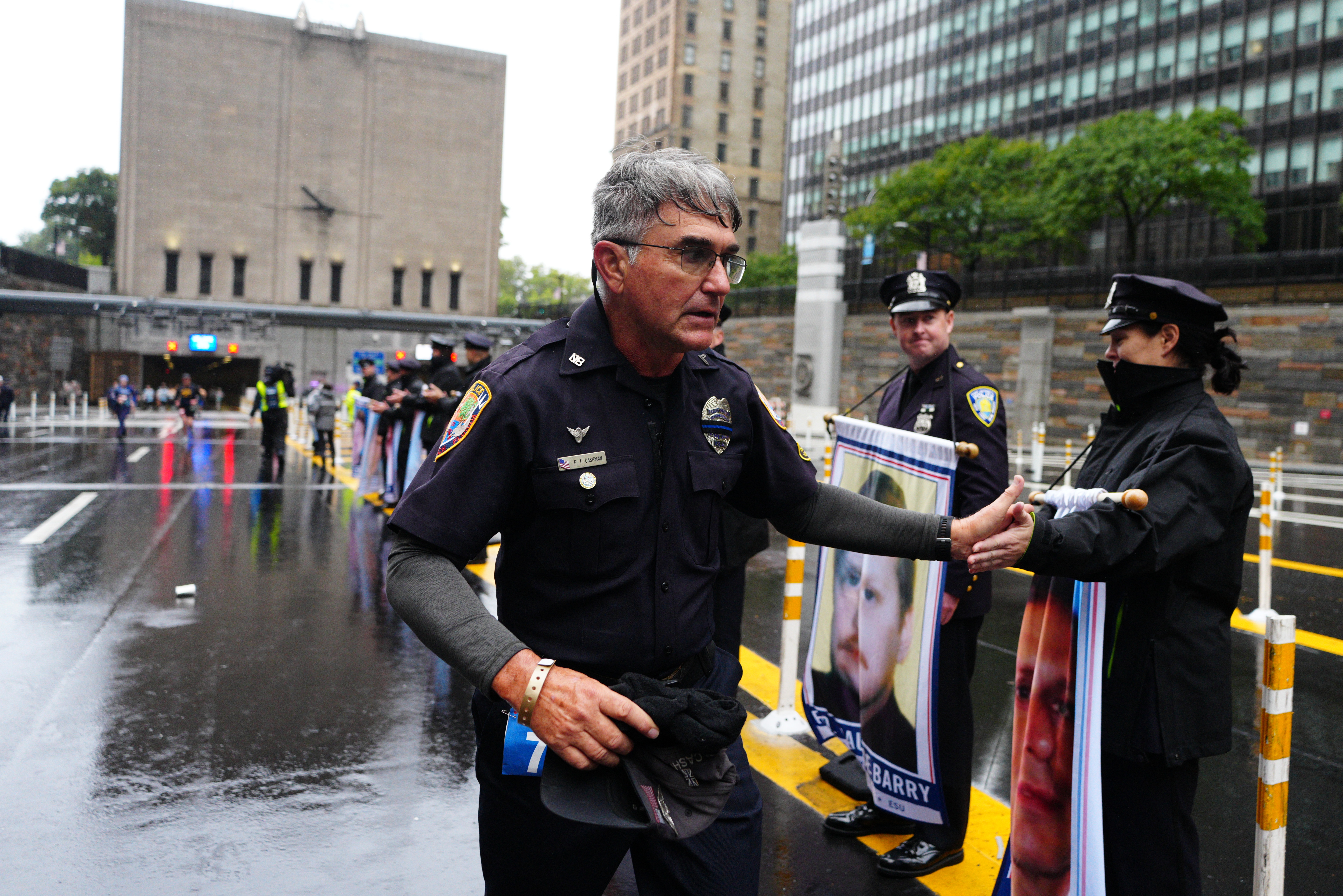 A police officer shaking hands with a runner at the 25th annual Tunnel to Towers NYC 5K Run & Walk.