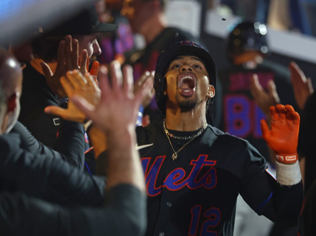New York Mets player celebrating during a baseball game.