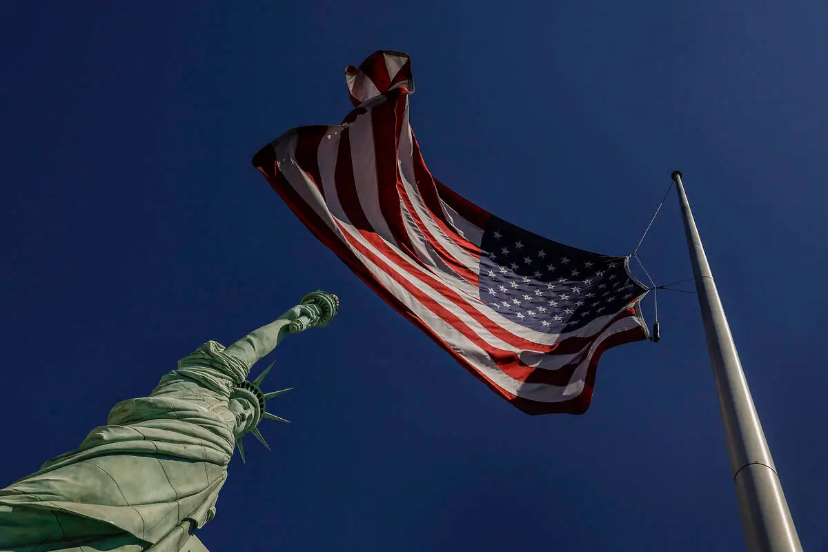 The America flag and New York-New-York’s replica Statue of Liberty are photographed duri ...