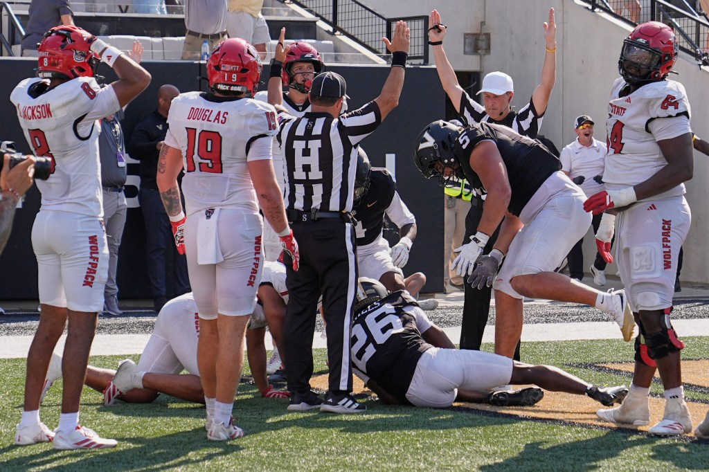 Officials signal touchdown after Vanderbilt cornerback Cayden Daniels (26) recovered a North Carolina State fumble in the end zone.