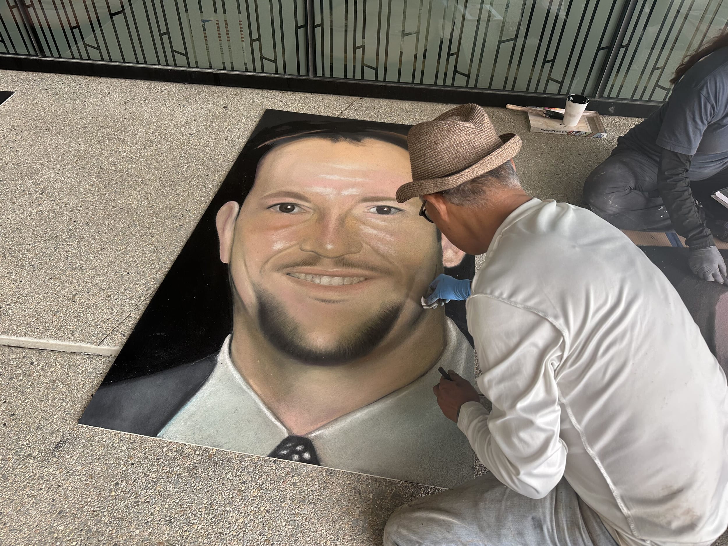 20 artists battled light rain and breezy conditions to put the final touches on chalk portraits of the 40 heroes aboard Flight 93.