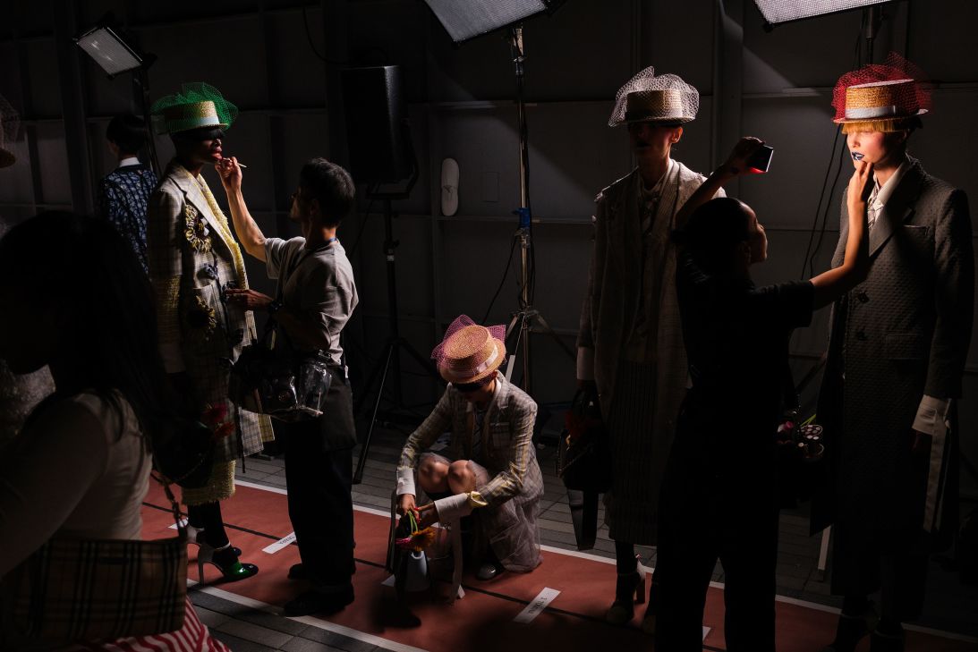Models prepare to grace the runway at Thom Browne.