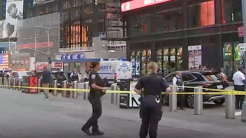 This image made from video provided by WABC-TV shows NYPD officers on the scene after a woman brandishing two large knives was shot by officers in Times Square in New York, Monday, Aug. 31, 2026. (WABC via AP)