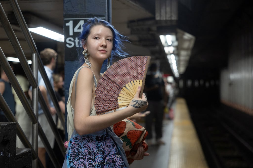 A woman fans herself at a subway station in New York City last month. Photo: Reuters