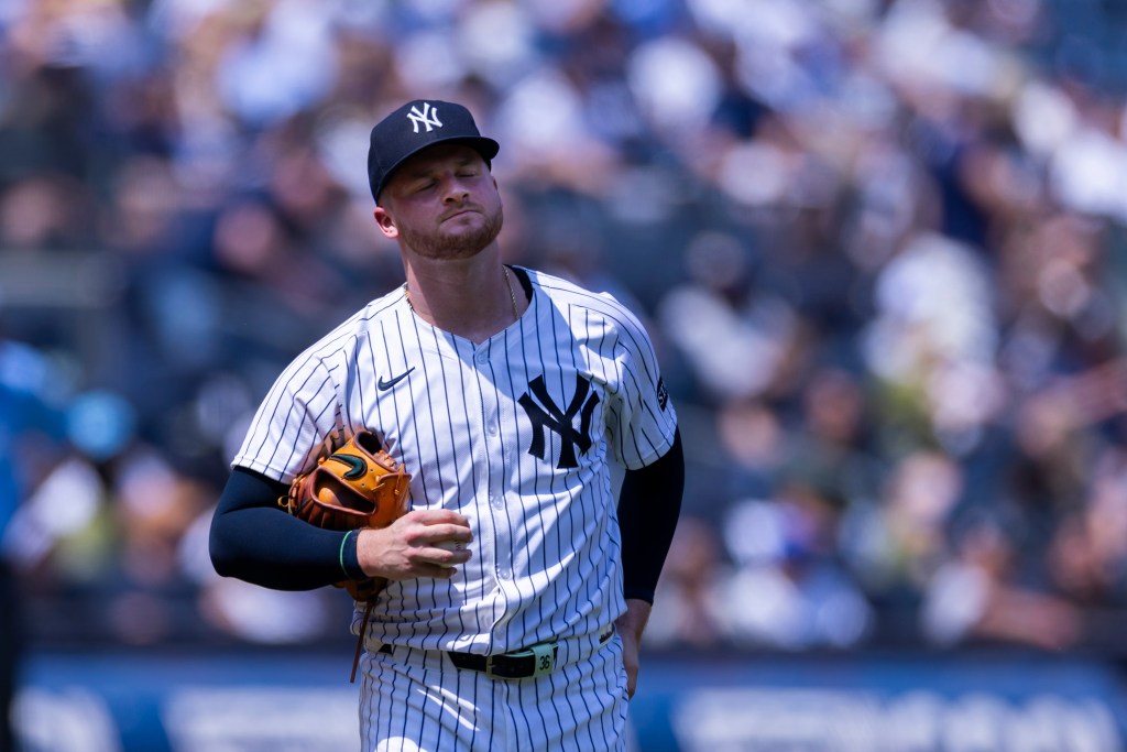 New York Yankees pitcher Clarke Schmidt reacting after Nick Kurtz of the Athletics scores.