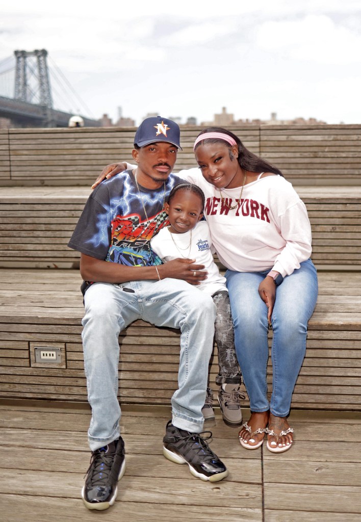 J Mark Roberts, 4, with his parents Gentle Roberts and Anyia James Roberts, posing for a portrait in Brooklyn, N.Y.