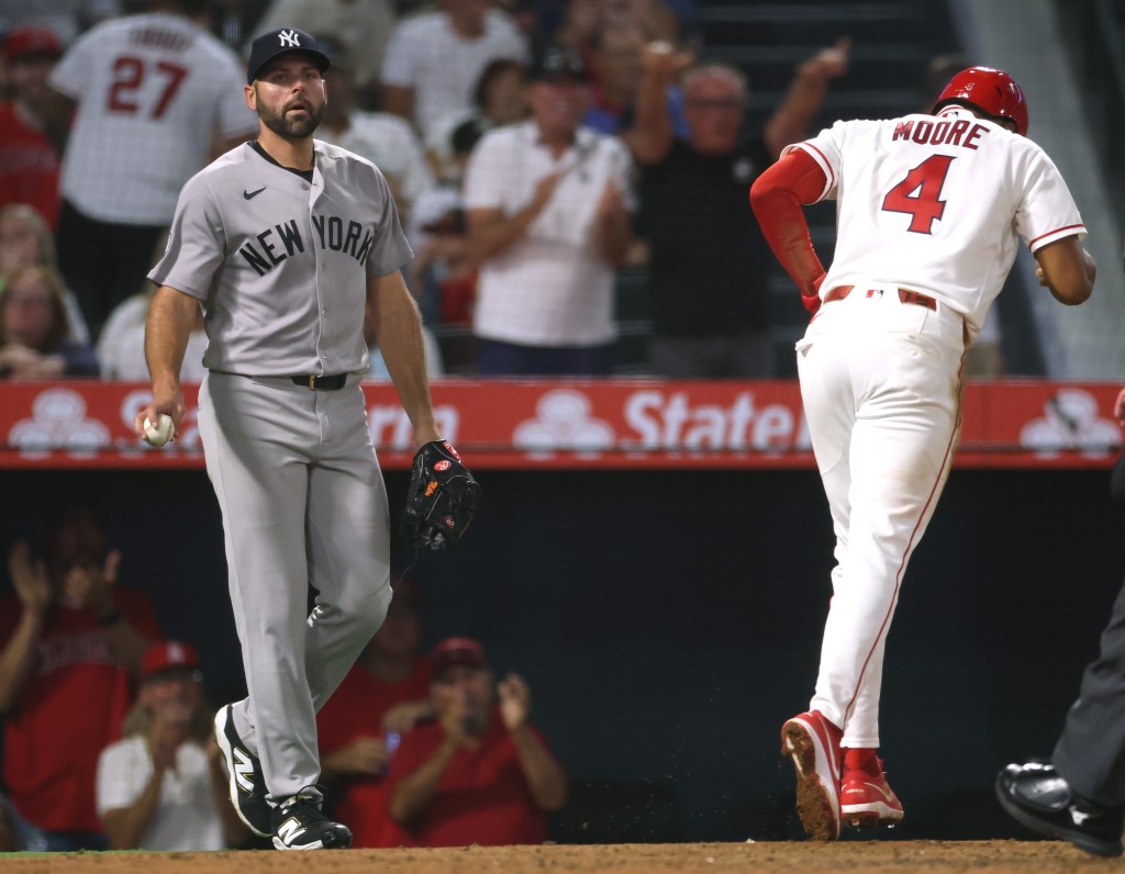 Michael Fulmer reacts to Christian Moore scoring after a failed pickoff attempt at second base.