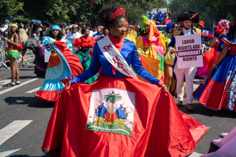 A young lady wearing a dress representing the Haitian flag walked along with other masqueraders during the West Indian Day Parade in Brooklyn, N.Y., Sept. 7, 2026. Photo by Fredner Cayemitte for The Haitian Times.
