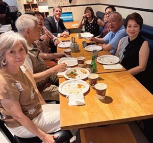 Assemblyman Edward C. Braunstein (top left) with com­munity leaders.