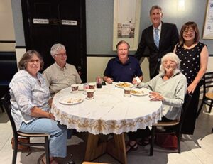 Susan Seinfeld (1st left), Ruthi Wimpfheimer (far right) with family, Assemblyman Edward C. Braunstein (standing) with Irene Cheung (standing).