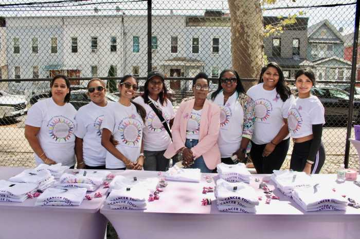 Selfless volunteers strike a pose, with Cancer Walk founder Allison Alexis, fifth from left, at the resource table of We Fight Cancer Together Inc. and Queens Cancer Walk in Smokey Oval Park, Richmond Hill on September 19.