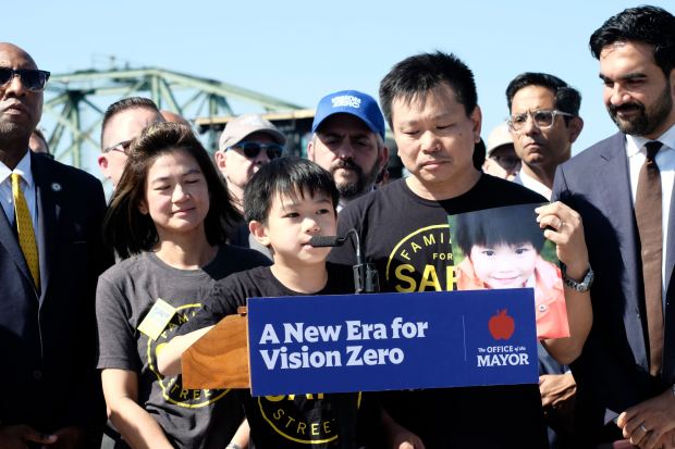 Aiden Liao, 12, stands with his parents, Amy Tam-Liao and HP Liao, as he talks about his sister, Ally, who was killed by a distracted driver, in Maspeth, Queens, on Tuesday, Sept. 15, 2026. (Evan Simko-Bednarski / New York Daily News)