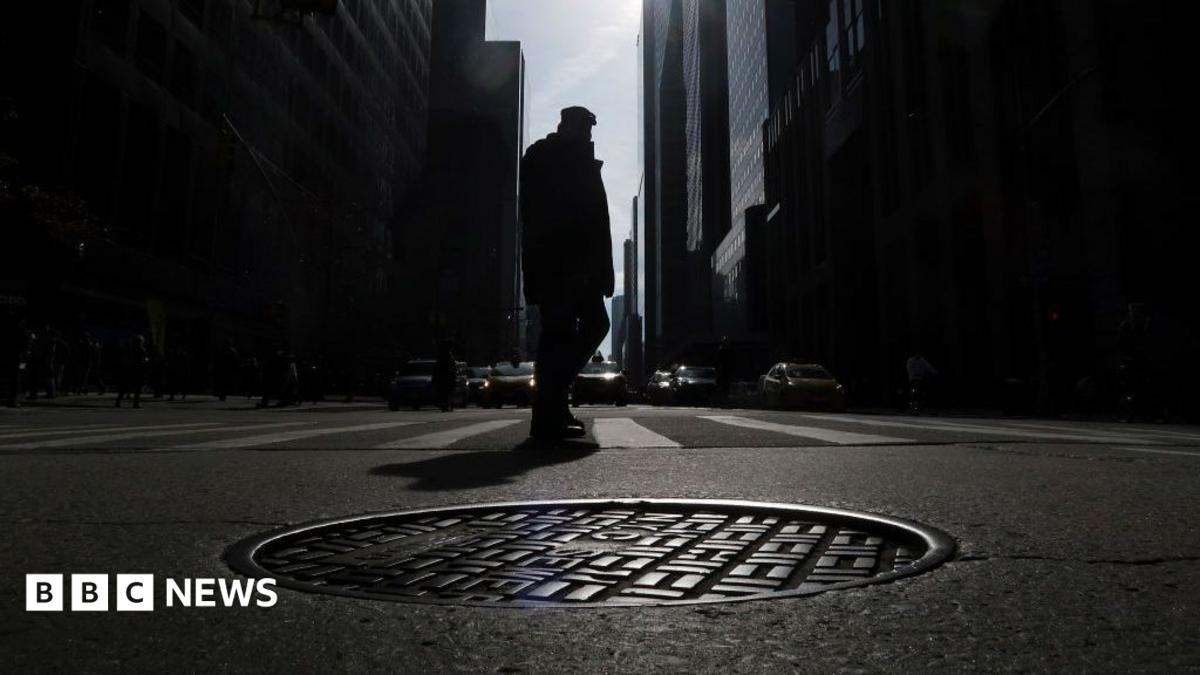 A photo of a manhole in New York City is shown