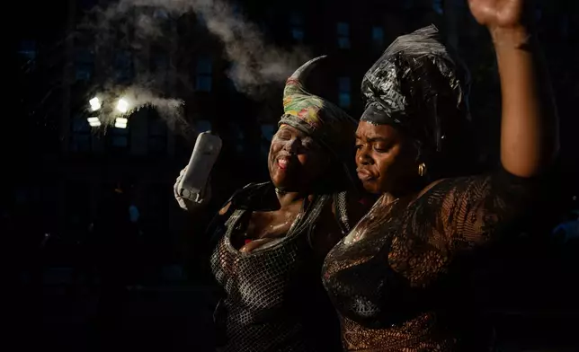 People participate in J'Ouvert festivities ahead of the West Indian Day Parade at sunrise on Labor Day in the Crown Heights and Flatbush neighborhoods of Brooklyn, Monday, Sept. 7, 2026, in New York. (AP Photo/Angelina Katsanis)