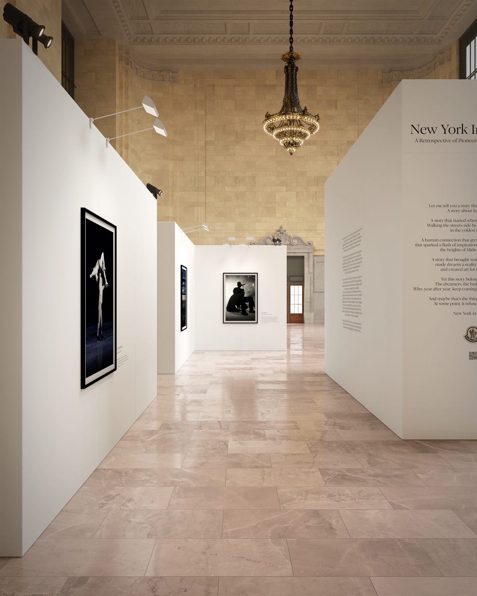 An art exhibition space showcasing photography with white walls and stylish lighting features.