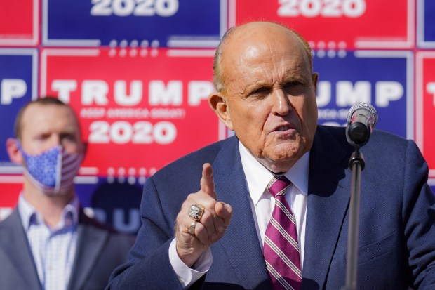 Former New York mayor Rudy Giuliani, a lawyer for President Donald Trump, speaks during a news conference at Four Seasons Total Landscaping on legal challenges to vote counting in Pennsylvania, Nov. 7, 2020, in Philadelphia. A review panel says Giuliani should be disbarred in Washington for how he handled litigation challenging the 2020 election on behalf of then-President Donald Trump. The panel's report was released Friday, July 7, 2023. (AP Photo/John Minchillo, File)