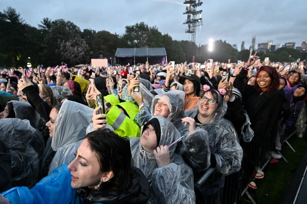 Festivalgoers stand in the rain during the Global Citizen Festival on Saturday, Sept. 23, 2023, at Central Park in New York. 