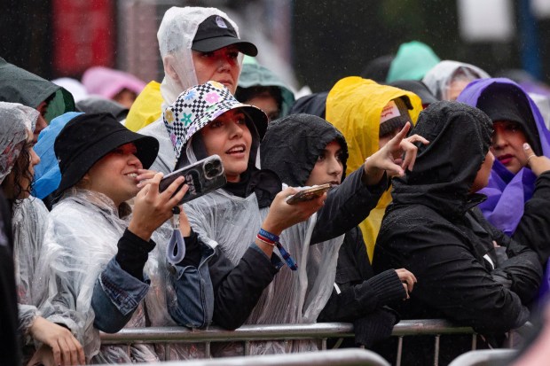 People wearing rain ponchos attend the Global Citizen Festival on Saturday, Sept. 23, 2023, at Central Park in New York. 