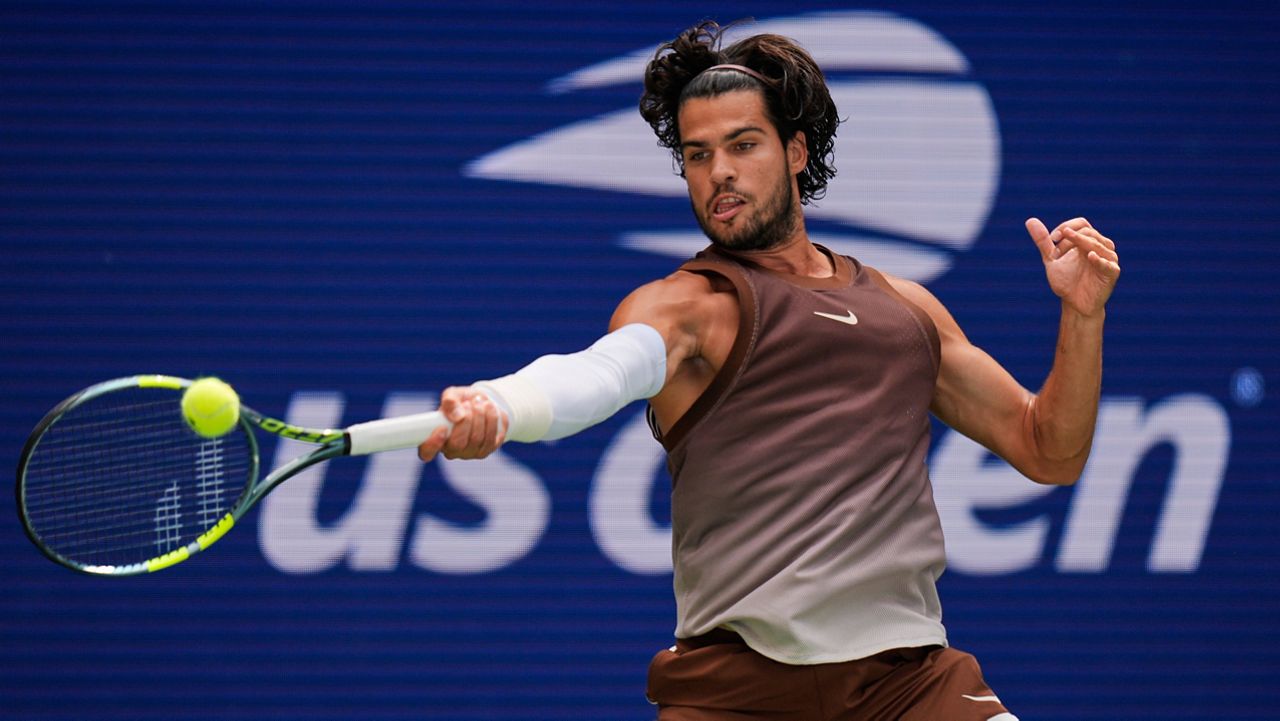 Carlos Alcaraz, of Spain, returns the ball to Roman Safiullin, of Russia, during the first round of the U.S. Open tennis championships, Monday, Aug. 31, 2026, in New York.