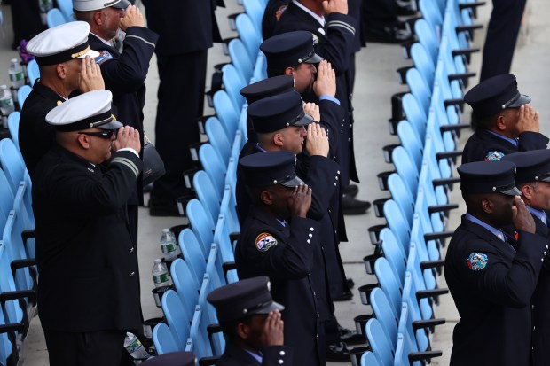 Members of the FDNY salute during the national anthem at a memorial to commemorate the 25th anniversary of the 9/11 attacks, Wednesday, Sept. 9, 2026, in the Staten Island borough of New York. (AP Photo/Pamela Smith)