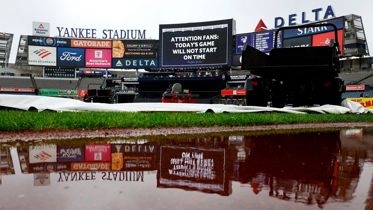 A game delay announcement is shown on the scoreboard before a scheduled baseball game between the New York Yankees and the Baltimore Orioles, Sunday, Sept. 27, 2026, in New York. (AP Photo/Noah K. Murray)