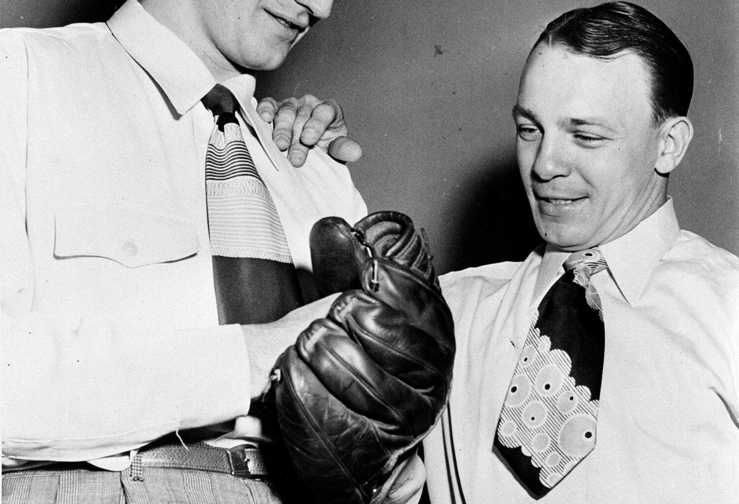 Ralph Branca, left, tries out the glove of teammate Eddie Stanky, right, Feb. 17, 1948, in Mobile, Ala. Photo: AP