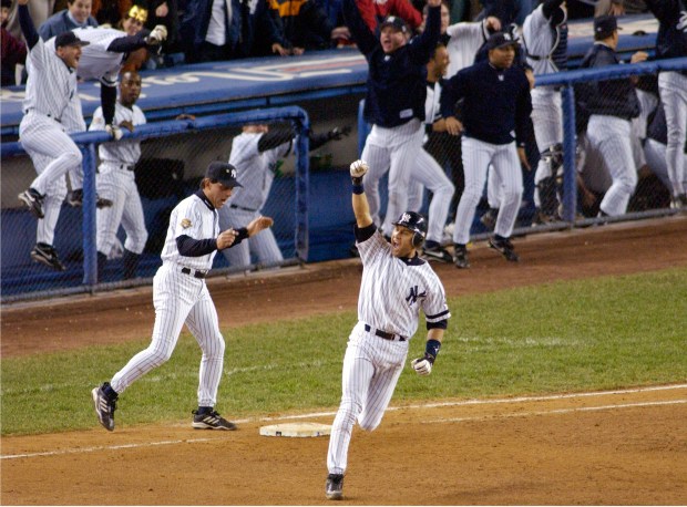 New York Yankees' Derek Jeter celebrates his game-winning home run in the 10th inning as he rounds first base in Game 4 of baseball's World Series against the Arizona Diamondbacks at Yankee Stadium in New York.
