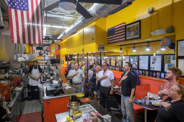 On the 25th anniversary of the 9/11 terrorist attacks, customers and employees stand for the daily Pledge of Allegiance at Chick & Ruth's Delly, where the Pledge of Allegiance has been recited in the morning, seven days a week since 1989, in Annapolis, Md., Friday, Sept. 11, 2026. (AP Photo/Rod Lamkey, Jr.)