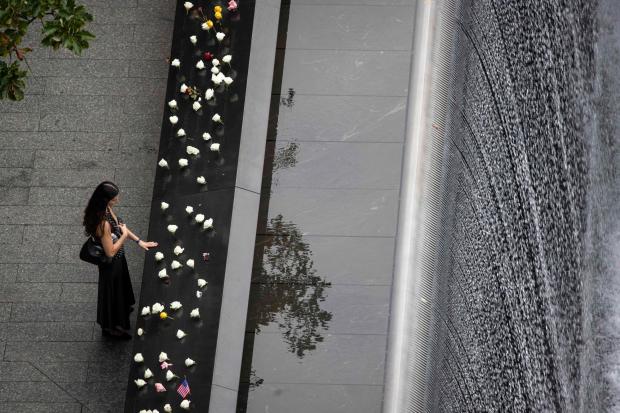 A woman mourns at the September 11 memorial plaza in Lower Manhattan ahead of a ceremony commemorating the 25th anniversary of the Sept. 11, 2001, attacks at the National September 11 Memorial in New York on Friday, Sept. 11, 2026. (Dave Sanders /The New York Times via AP, Pool)