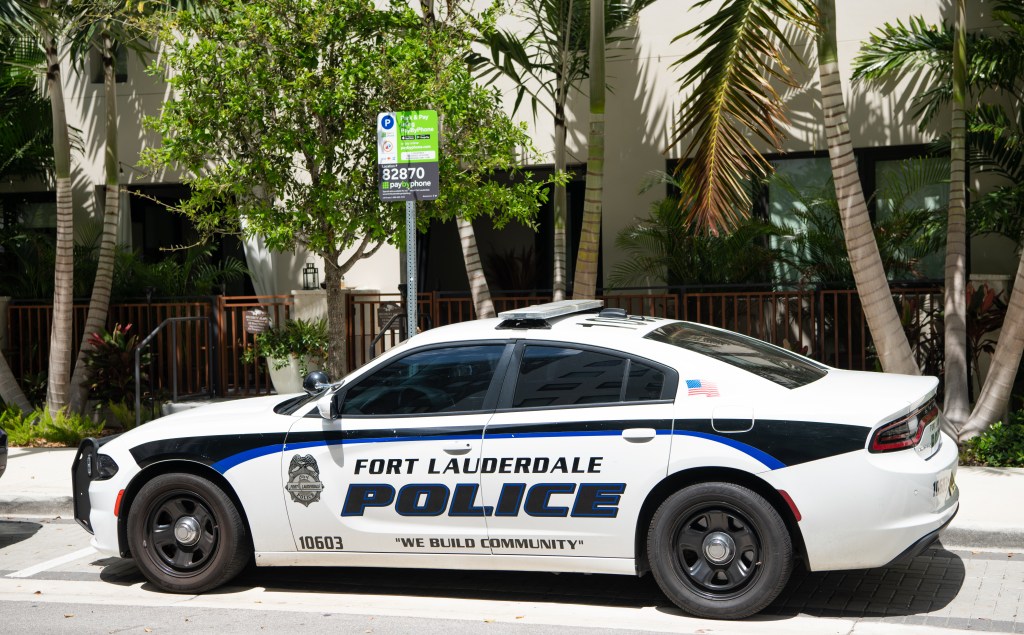 Side view of a white Dodge Charger Fort Lauderdale Police emergency car.