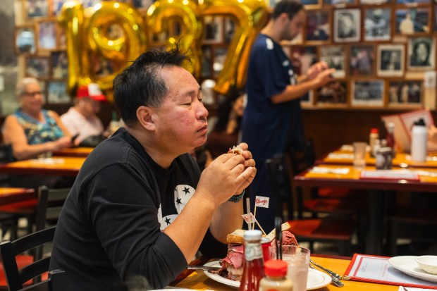 A customer enjoys their meal during the opening of Carnegie Deli on Tuesday, Sept. 15, 2026.