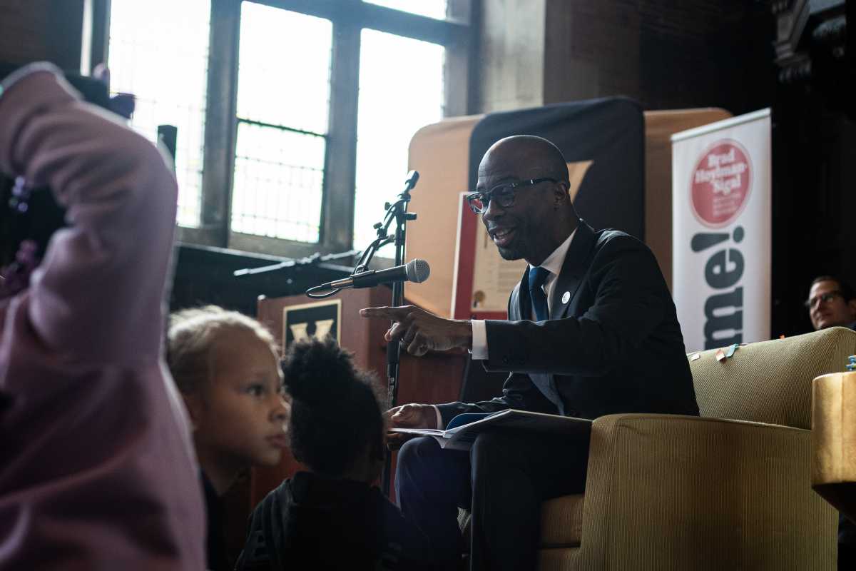 New York City Schools Chancellor Kamar Samuels reads to kids at the event.