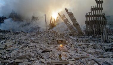 A New York City firefighter steps through the wreckage of the collapsed World Trade Center on the morning of Sept. 12, 2001.