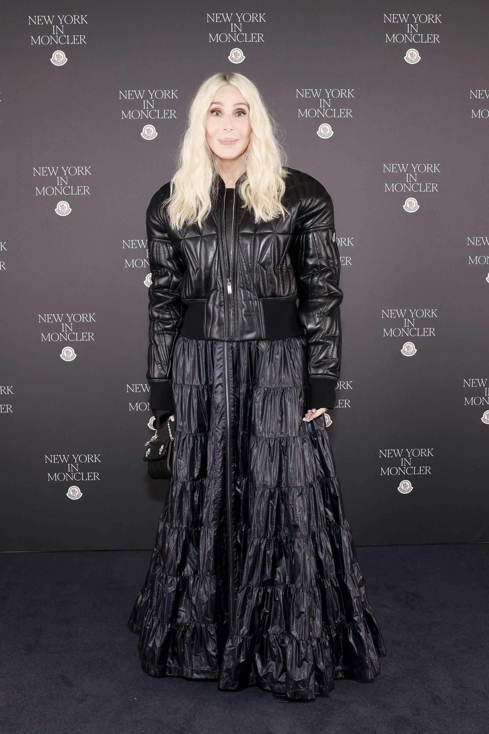 Image may contain Cher Clothing Coat Adult Person Blonde Hair Jacket Fashion Accessories Bag and Handbag